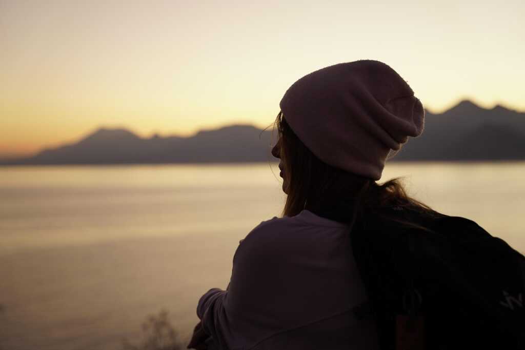 woman, outdoors, sunset, beanie, travel, thinking, looking, nature, nostalgia, dusk
