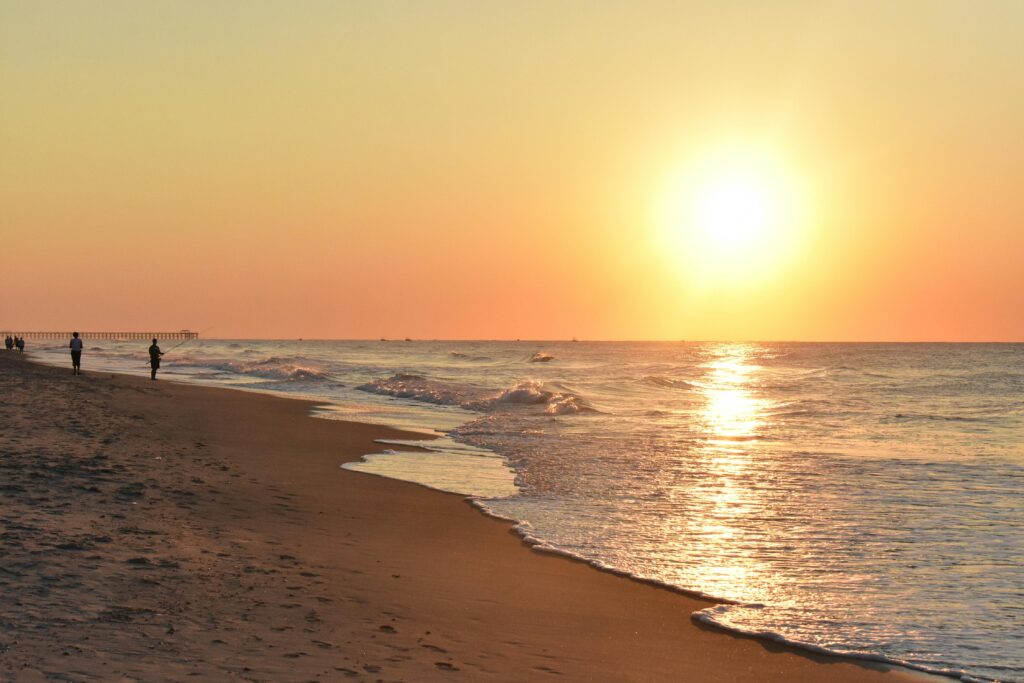 Serene sunrise at Myrtle Beach, with waves gently lapping the sandy shore.